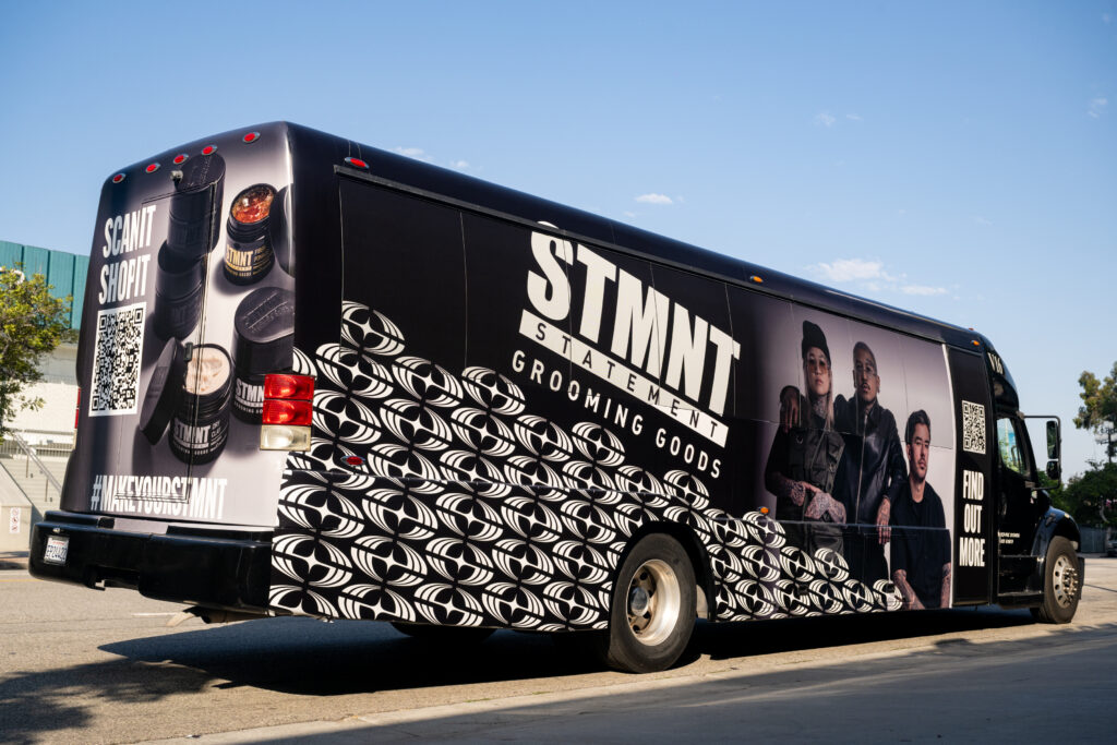 Bus Wrap Inc. mini bus wrap for STMNT Grooming Goods summer 2025 tour in Los Angeles, CA with bold branding