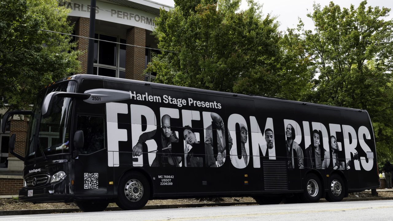 Bus Wrap Inc. full coach wrap for Harlem Stage East Coast tour with bold promotional branding