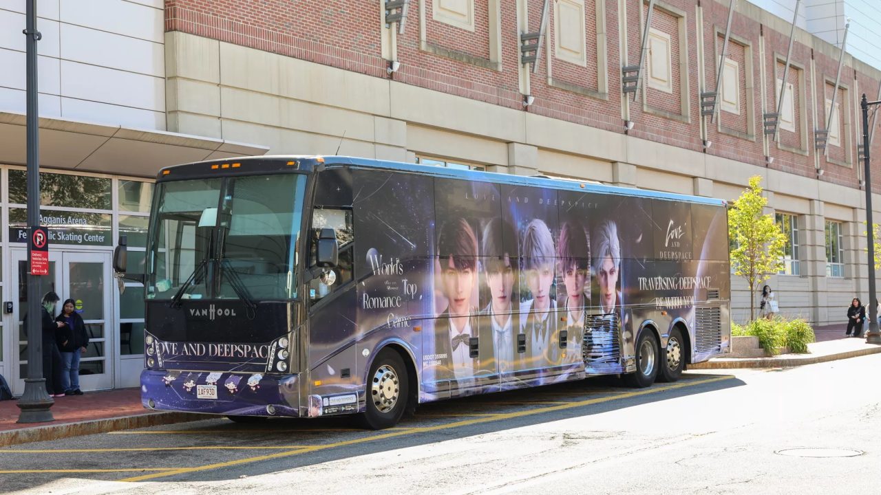 Bus Wrap Inc. full coach wrap for Love and Deepspace in Boston, MA with vibrant cosmic-themed graphics